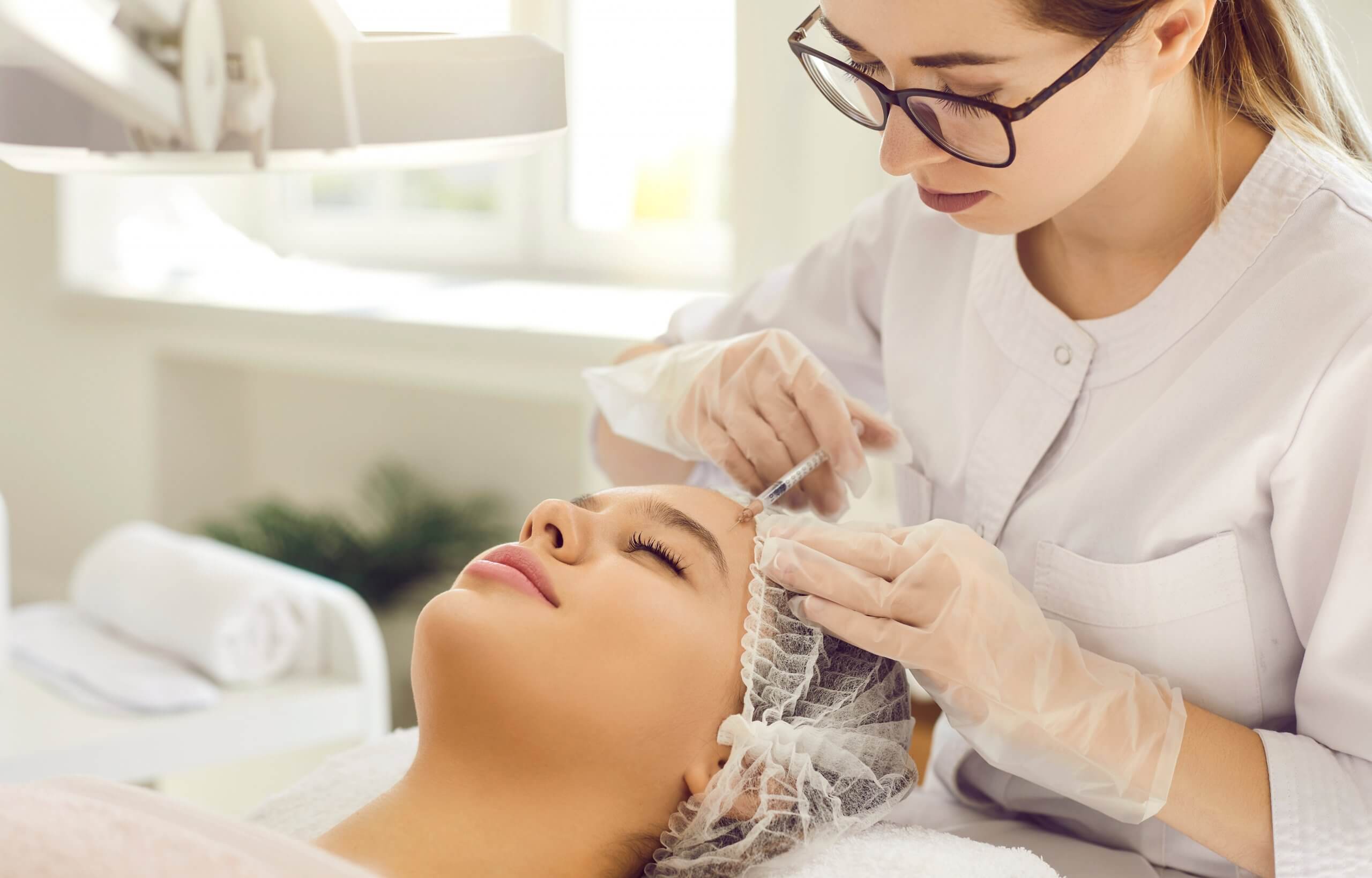 medical aesthetic nurse performing injections on a client