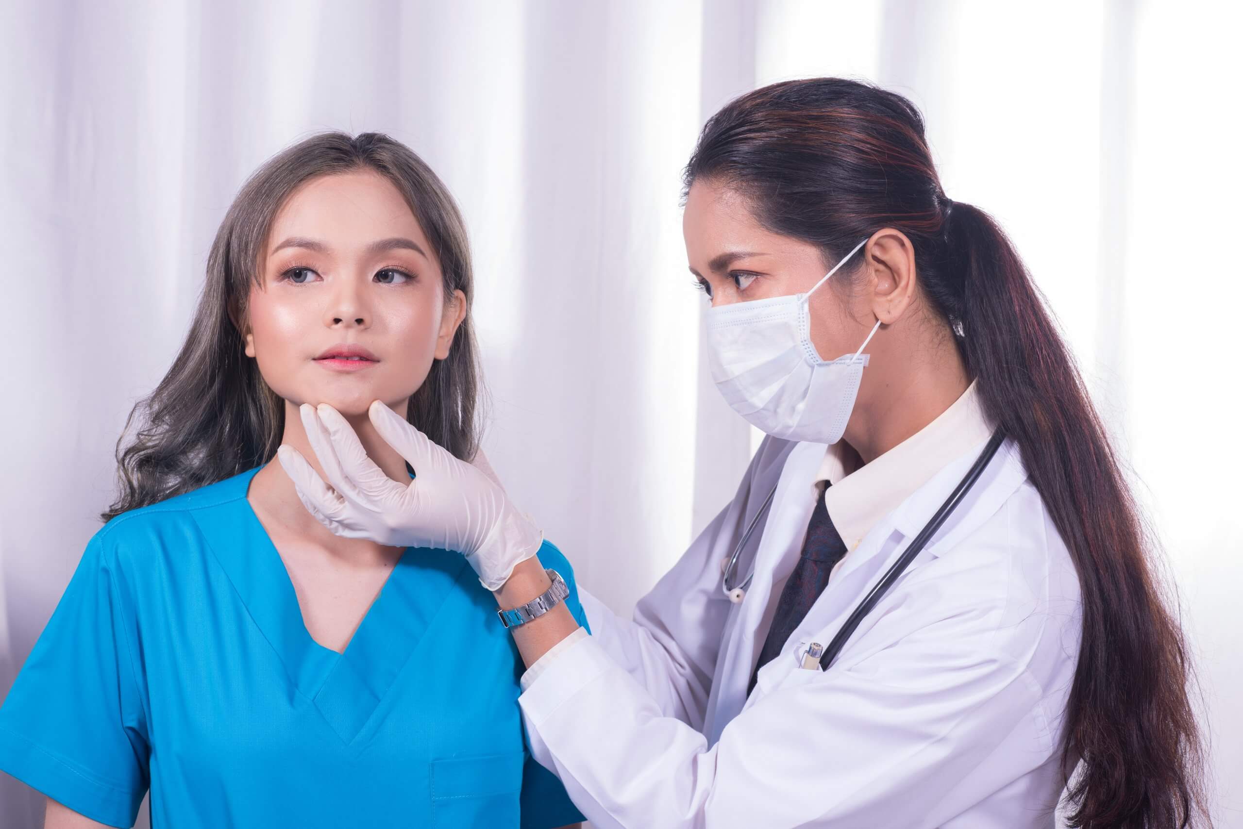 aesthetic nurse evaluates her client for treatment