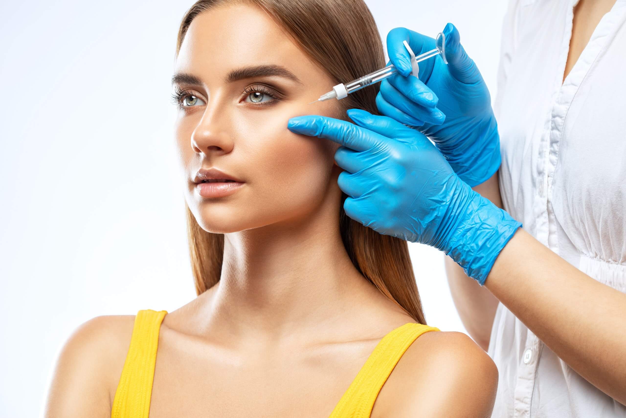 dermal fillers being injected into the cheekbone to provide a more defined appearance