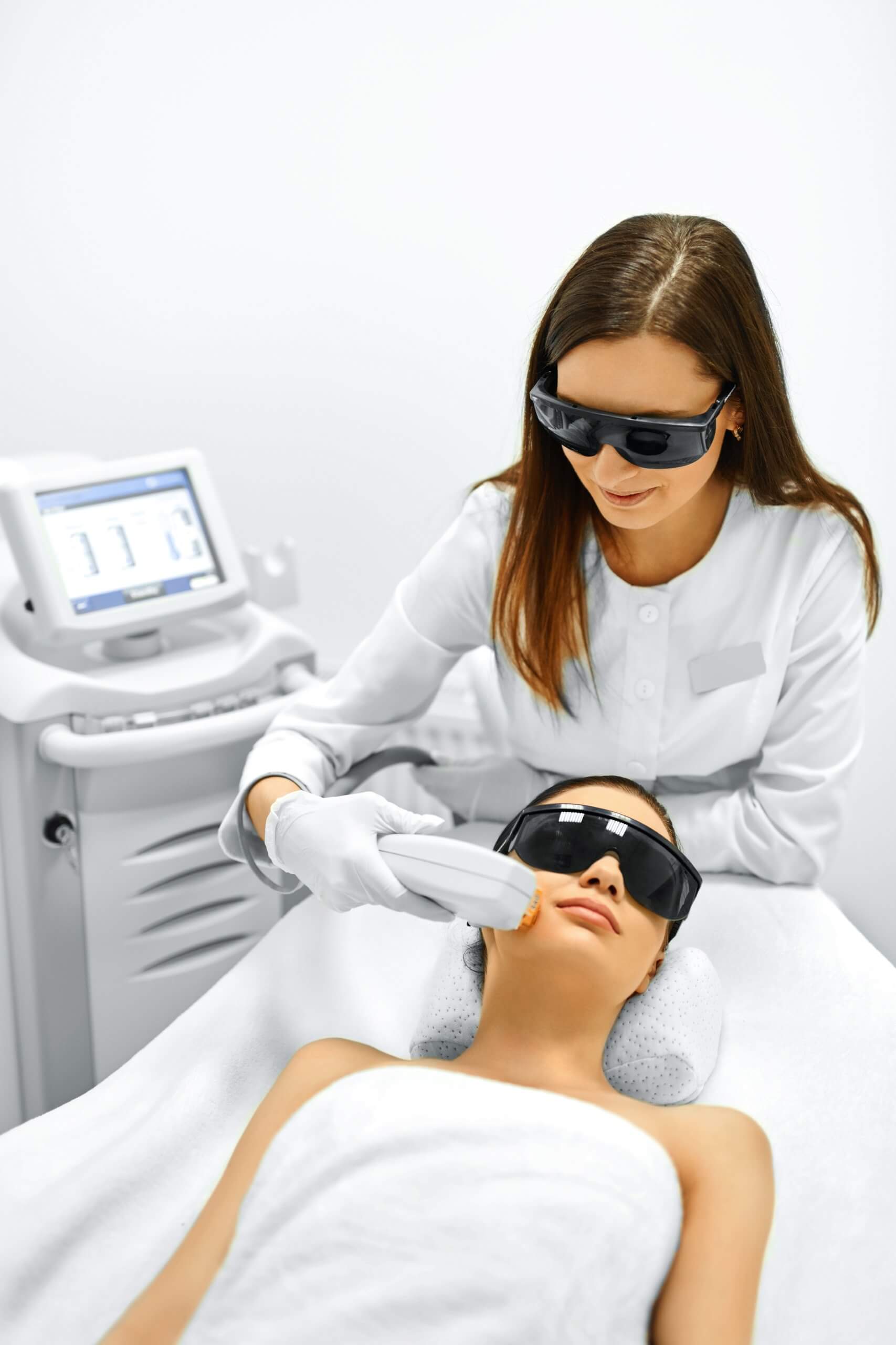 woman who has taken aesthetic laser training is completing a treatment on a client