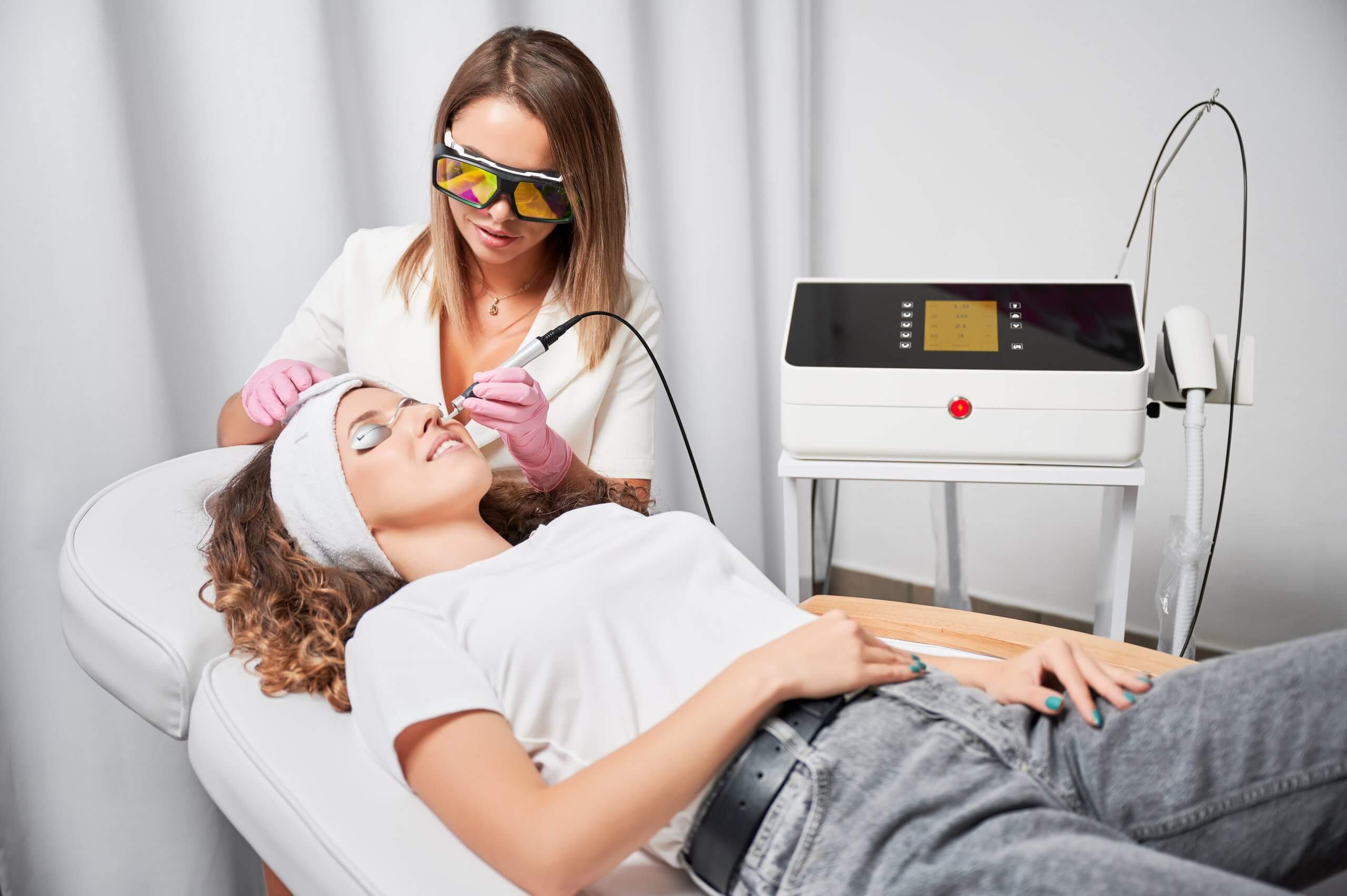 cosmetic laser technician performing a treatment on a client