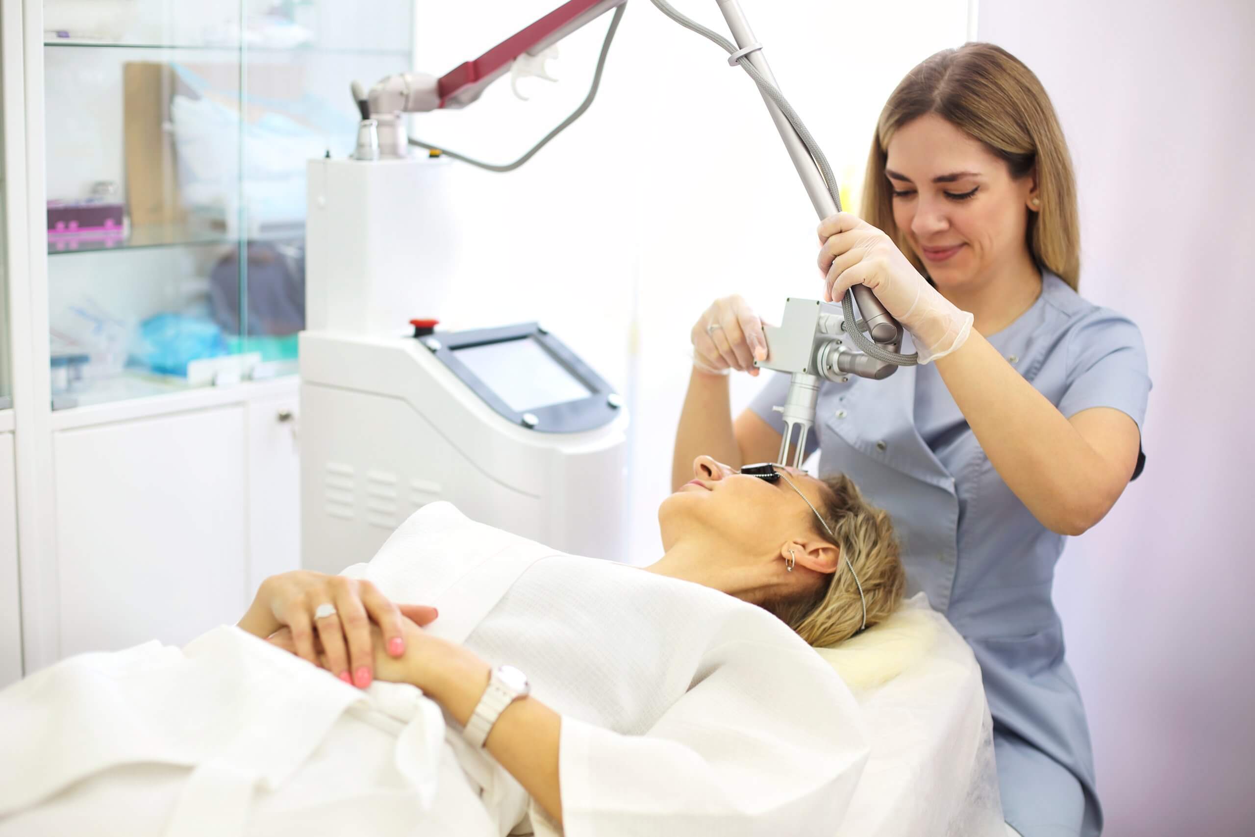 woman receiving Photofacial under careful watch of a trained cosmetic laser technician specializing in laser skin rejuvenation